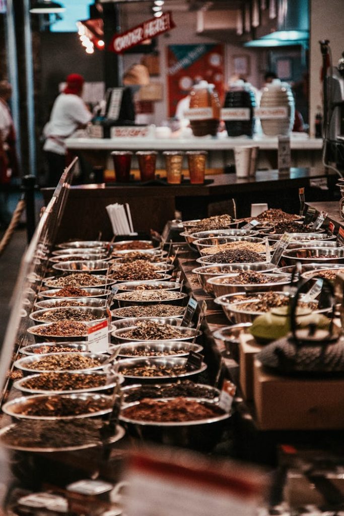 Colorful spice stall in New York City market, showcasing diverse aromatic herbs and spices.